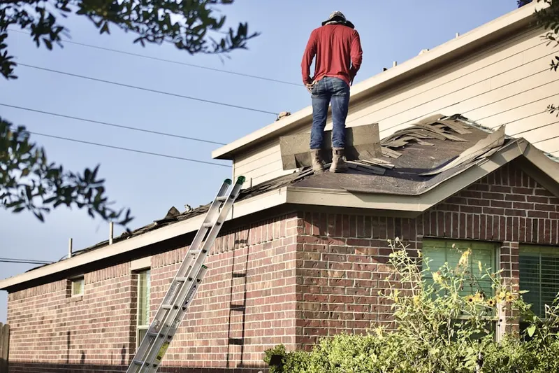 Professional roofer working on a residential roof in Perch Creek